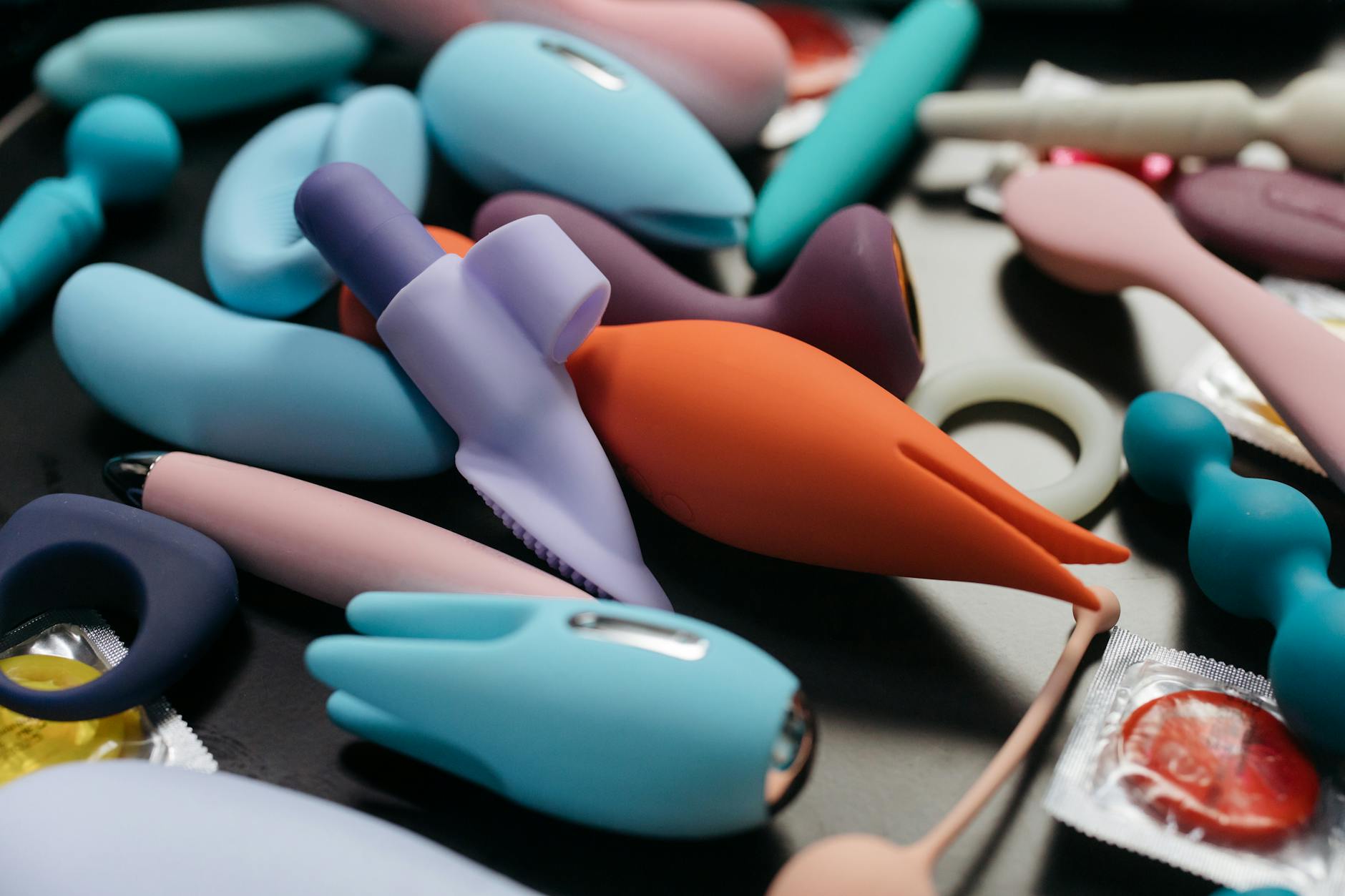 Hands holding a blue lemon clitoral vibrator against a purple background during recovery