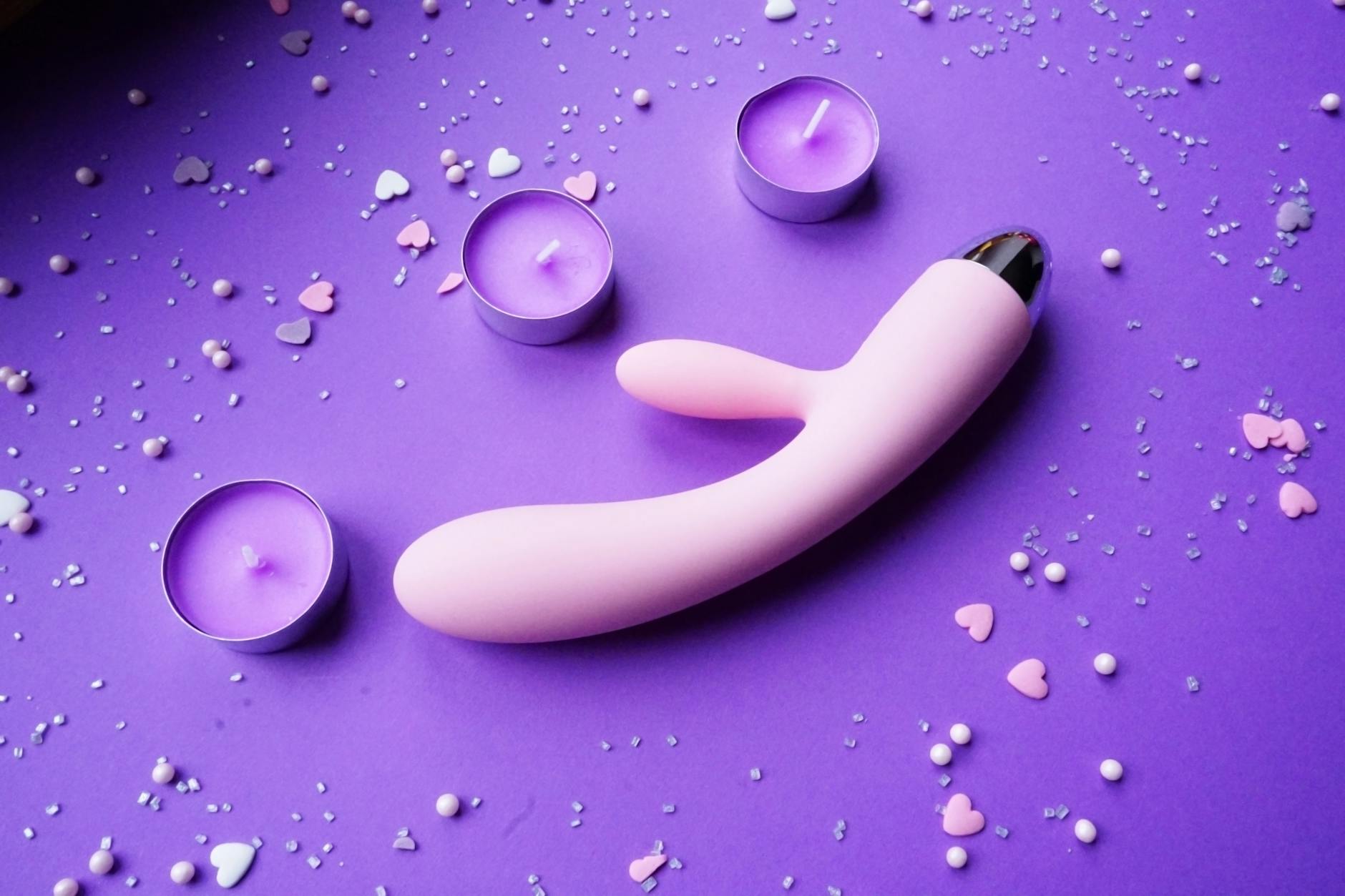 A couple standing together indoors, holding a vibrator and looking comfortable, symbolizing modern shared intimacy